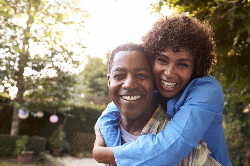 happy couple outside by trees