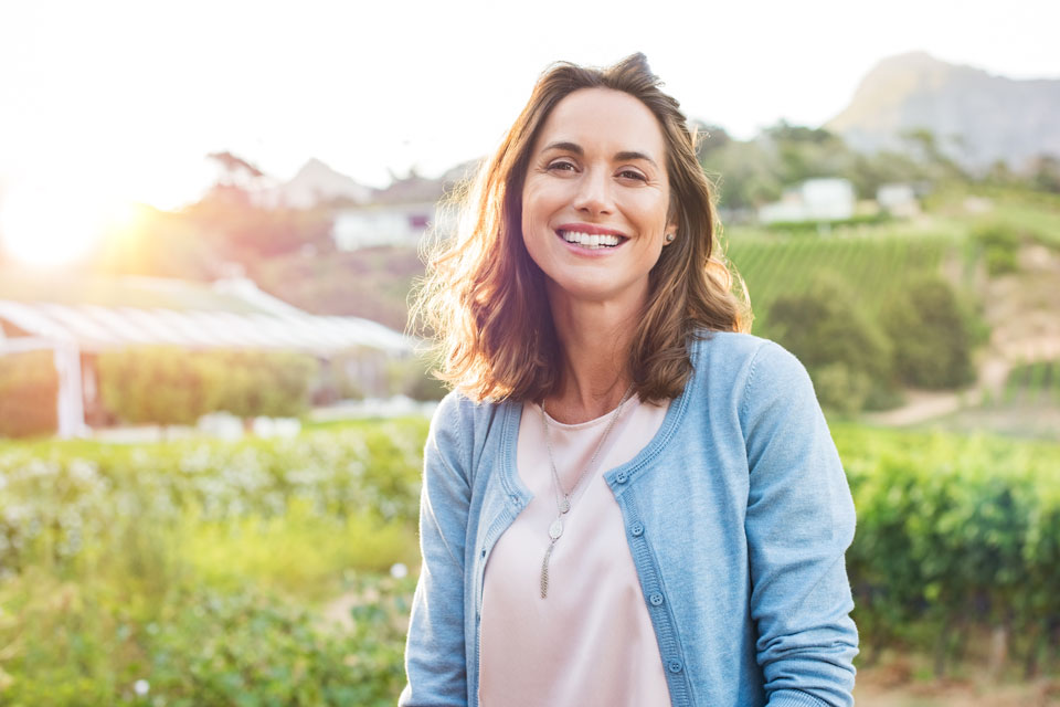 woman outside in field smiling