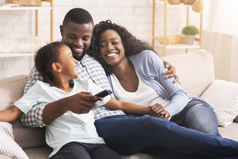 family inside watching tv