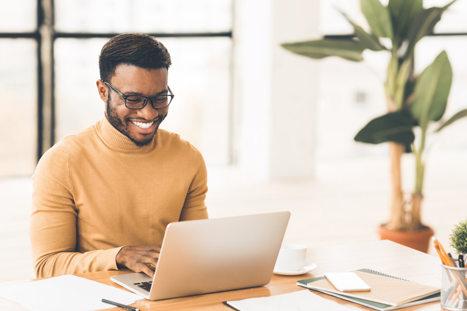 happy man working on laptop