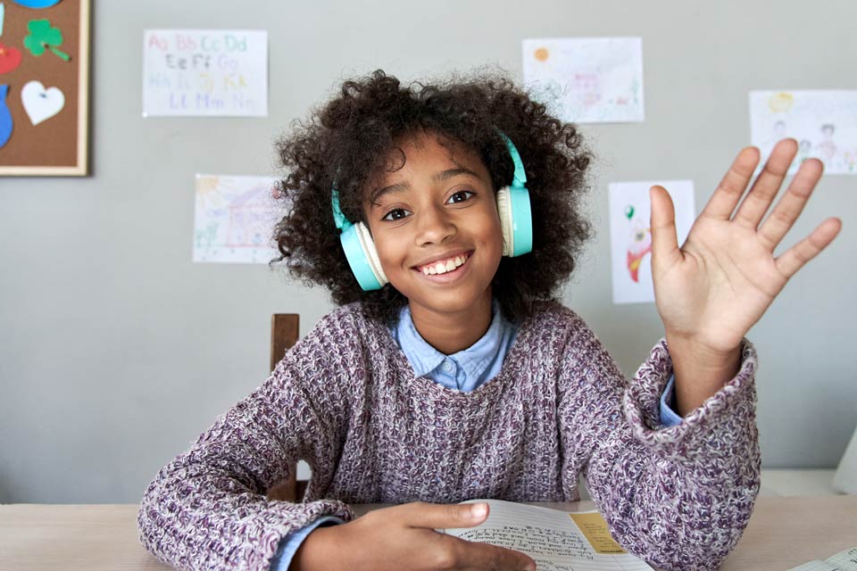 child smiling wearing headphones